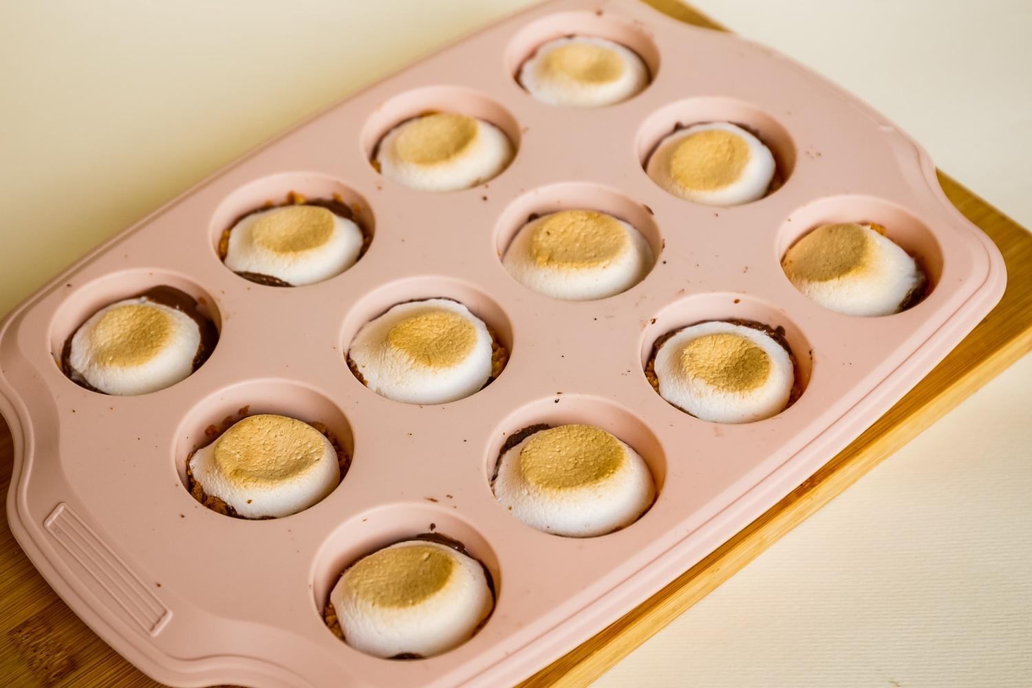 S'mores cups out of the oven in a silicon muffin pan