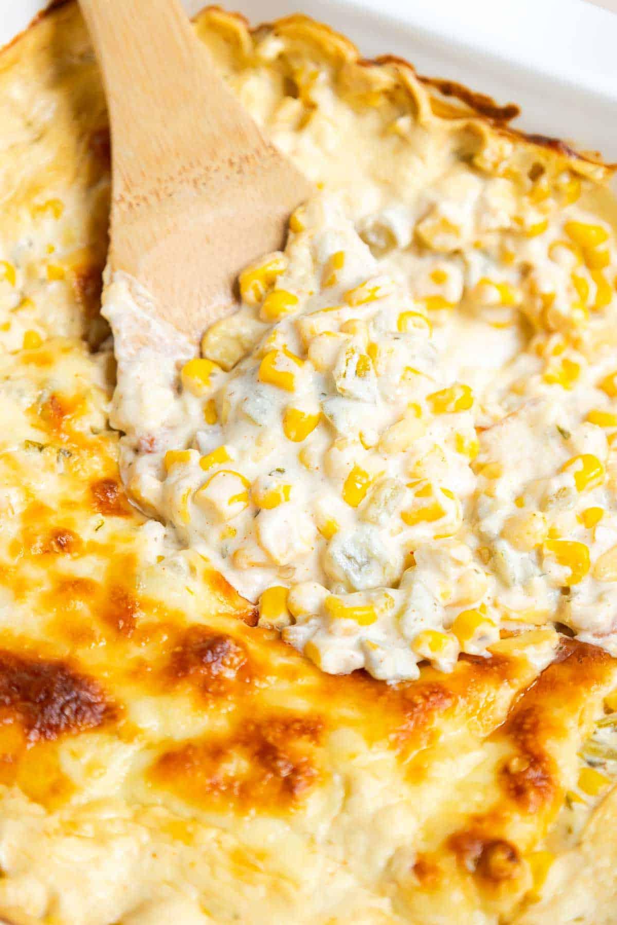 A scoop of the green chile corn casserole shows the creamy consistency.