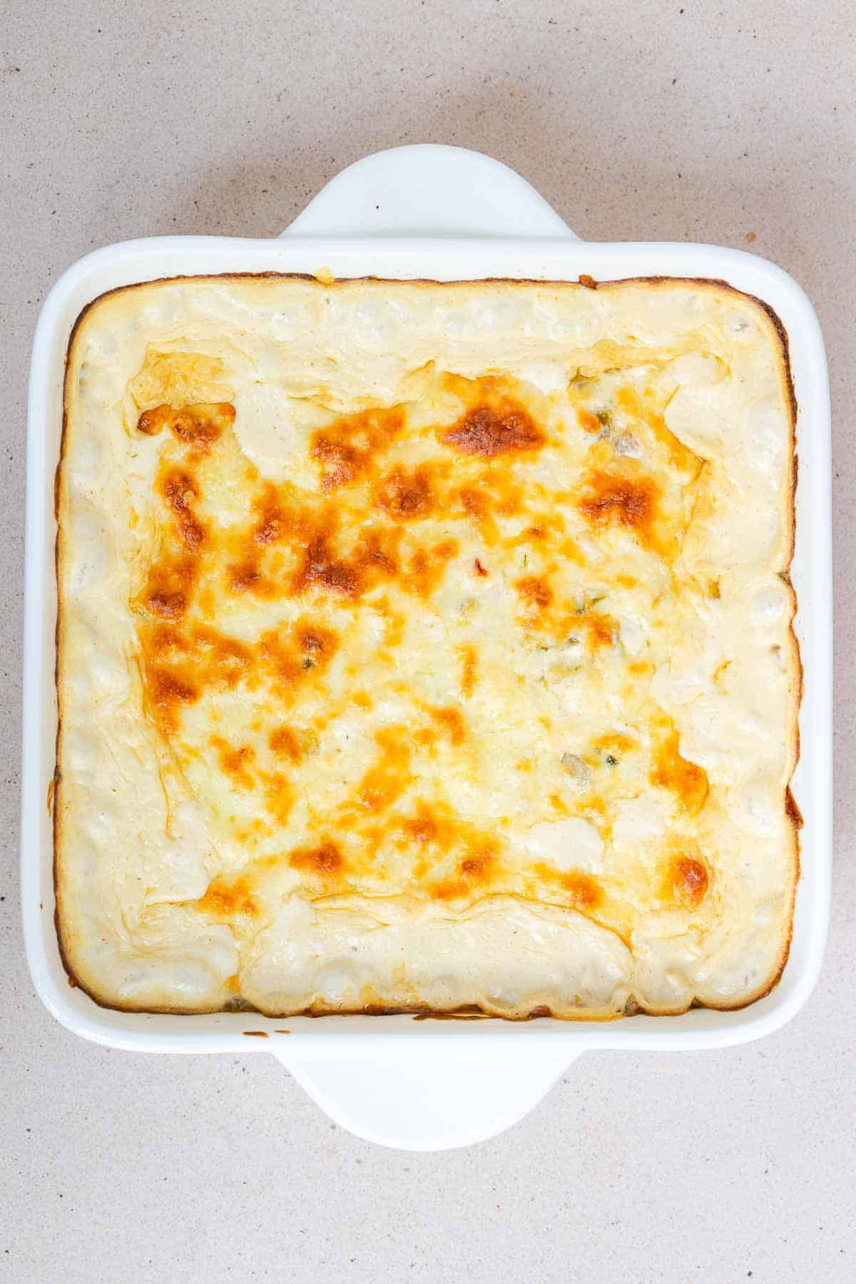 The green chile corn casserole is baked until bubbling and the cheese is golden.
