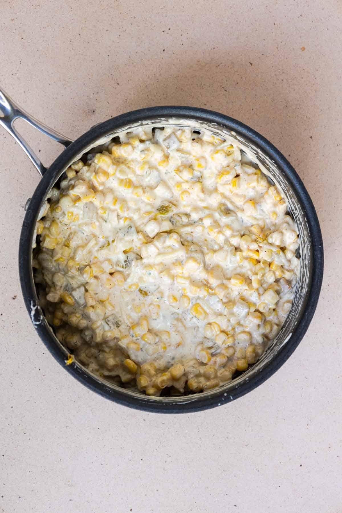 The corn casserole ingredients are mixed together in the saucepan until combined.