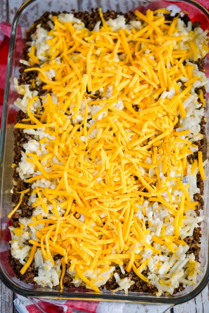 The remaining shredded cheddar cheese is added to the dish after it has baked.