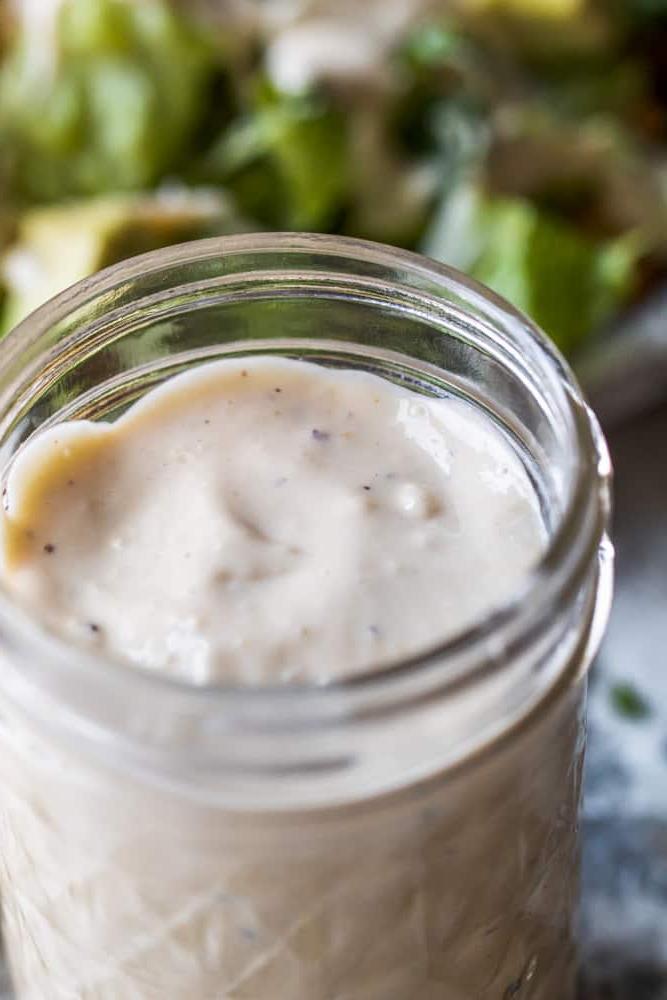Angle shot of dressing in a glass mason jar.