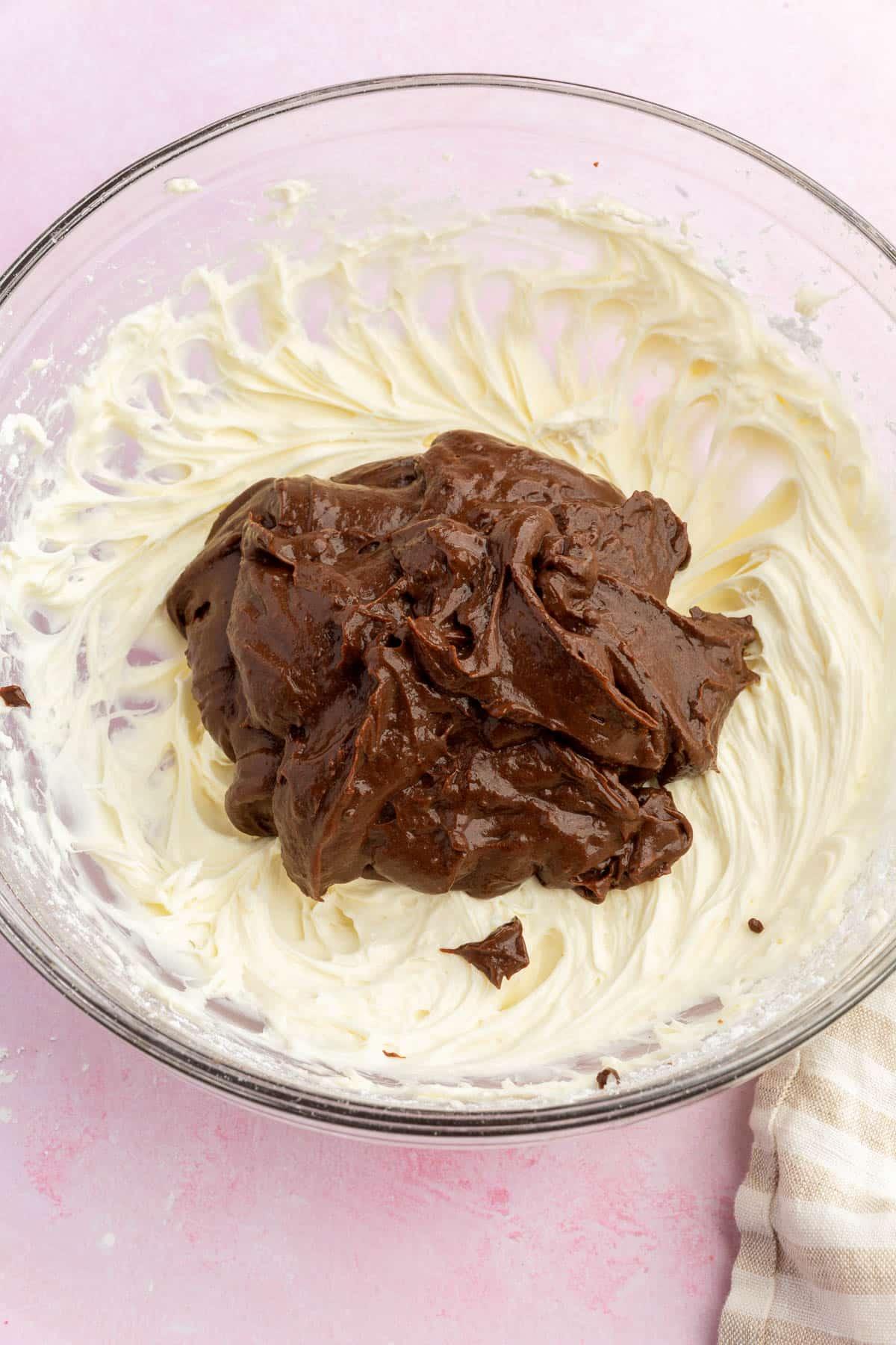 A cream cheese mixture topped with chocolate pudding.