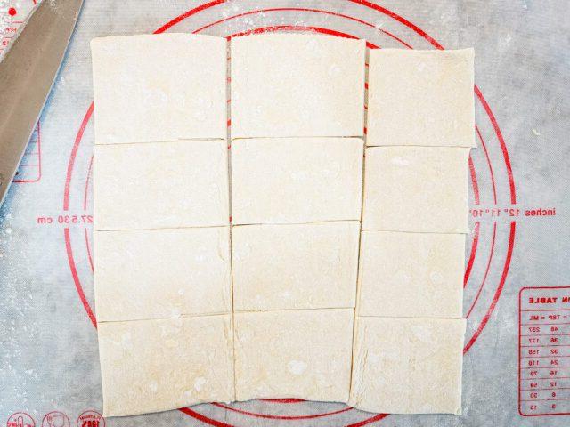 Cut the 2 sheets of puff pastry into 24 squares.